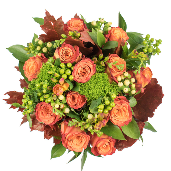 Viewed from above on a crisp white surface, this hand-crafted autumn bouquet reads like a small harvest landscape. The composition is densely packed and circular, anchored by many fully open roses whose colours travel from soft, glowing peach at their cores through coral and orange, ending with a faint reddish-rust on the outer petals as if kissed by the first cool breezes of fall. Interwoven throughout are clusters of small, waxy berries - vivid lime-green next to pale cream and gentle yellow orbs - that give the arrangement tiny points of light and a tactile, bead-like rhythm. Among these, rounded cushions of green trick dianthus add an unexpected, mossy texture, their dense, almost spongy forms contrasting with the smooth, spiralling rose petals. Rich, lobed leaves in deep burgundy and burnt orange are placed to echo fallen oak shapes, their dry, rustic tones bringing autumn's grounding warmth. Fresh glossy greens, some broad and shiny, some softly serrated, create a lush backdrop and hold the eye across the arrangement. The bouquet is presented in soft, even light that lifts the warm hues and sculpts gentle shadows, producing a feeling of cosy abundance - a piece made for dining tables, seasonal decor, or a thoughtful gift to convey gratitude and comfort. There's a subtle imagined scent: the familiar sweetness of roses tempered by leafy, earthy notes, very much the kind of seasonal selection a local Chingford florist might choose for harvest celebrations near Chingford Mount and Queen Elizabeth's Hunting Lodge.