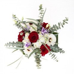 There is artistry and subtle confidence in this full-bodied bouquet, lovingly arranged by an expert Chingford florist. The ensemble begins with luminous white gerbera daisies, their broad, creamy petals radiating from deep brown centers like gentle suns, embraced closely by sumptuous red roses whose velvety textures exude lasting affection. Interwoven among these are wisps of lilac lisianthus-some tightly closed, others opening with quiet anticipation-bringing a whisper of modernity and serene beauty. Puffs of petite white filler flowers lend the arrangement a billowy softness, reminiscent of the cloud-streaked skies above Epping Forest. Glossy, structured leaves envelop the base, their dark green sheen grounding the display, while sprigs of eucalyptus with silver-green discs arch gracefully outward, introducing movement, layered fragrance, and elegant depth. Clear glass offers a window to the thriving stems-freshly cut, vibrant, and alive. Every stem and texture has been chosen to echo the character of Chingford's neighborhoods: a blend of tradition, renewal, and understated charm. Designed for milestone celebrations, new beginnings, or simply to brighten a loved one's day, this arrangement from Chingford Flowers is a testament to local craftsmanship and heartfelt service.