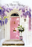 This doorway scene in Chingford feels like the moment just before someone turns the key on their first evening in a new home. The central focus is a soft pink front door, painted in a gentle, welcoming shade that glows subtly in diffused natural light, reminiscent of a calm afternoon along the edges of Epping Forest. The door is framed by whitewashed walls with a similarly toned shutter, the paint slightly brushed and textured, giving the façade an inviting, lived-in warmth rather than a stark, new-build finish. Above and to the sides, mature wisteria drapes in sweeping clusters of lavender and lilac blossoms, each flower hanging in loose, fragrant garlands that transform the entrance into a floral archway. The foliage weaves in and out, casting delicate, lacy shadows that move with the changing light. At the doorstep sits a florist's bucket in a soft grey metal, its simple, functional shape elevated by the generous bouquet it contains. White and creamy roses, at different stages of opening, fill the bucket to the brim, their velvety petals catching the light and creating subtle ivory and soft butter tones. Sprays of fresh green foliage break up the pale palette with just enough contrast to keep the eye moving. A pink ribbon, tied with care around the bucket, links the blooms visually back to the door, creating a harmonious pastel story. The whole composition feels gentle yet full of promise, like a housewarming gift delivered across Chingford by a florist who understands how flowers can turn an unfamiliar doorway into a place that already feels like home, full of possibility and quiet joy.